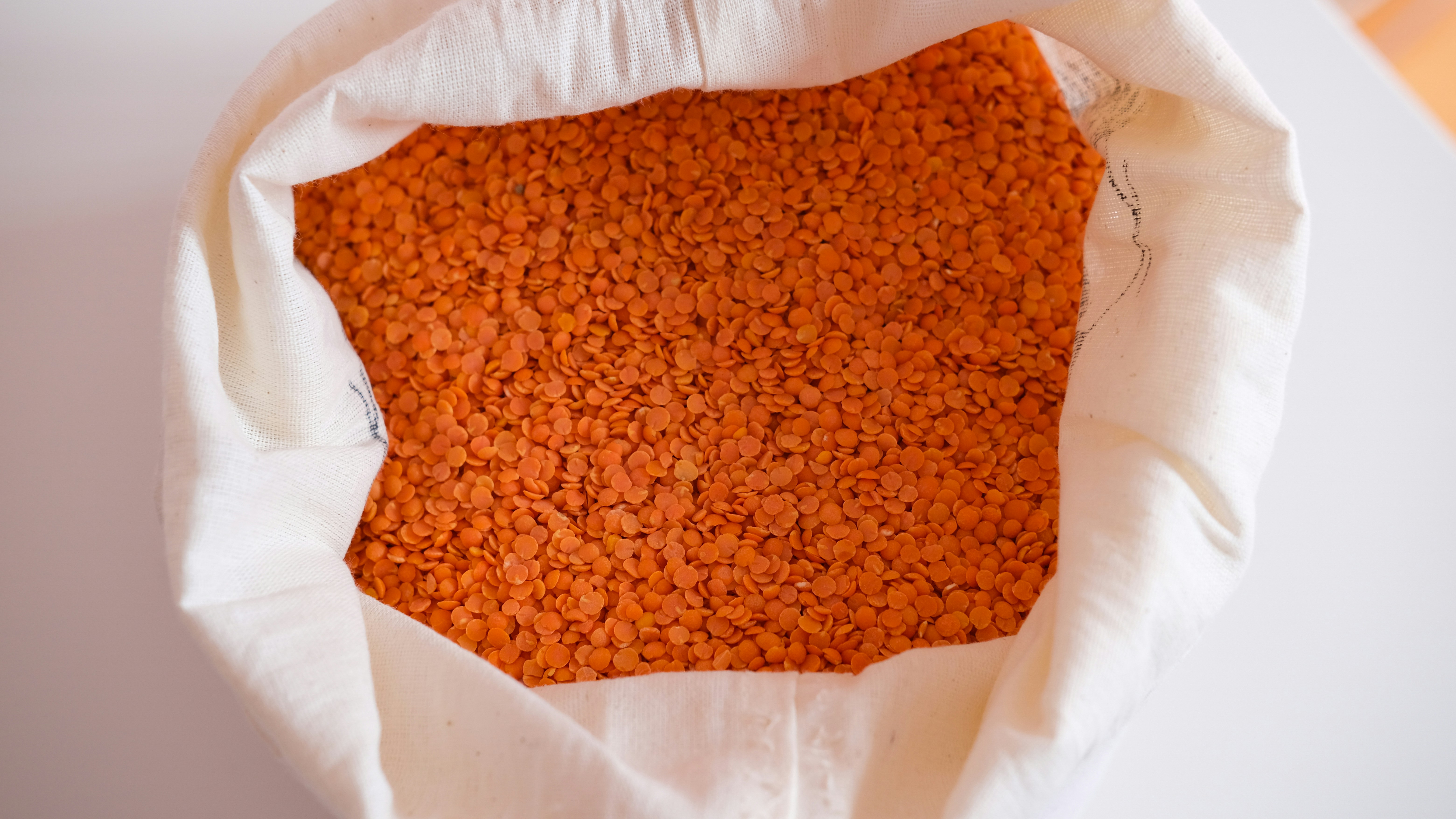 A piece of orange material is in a white bag