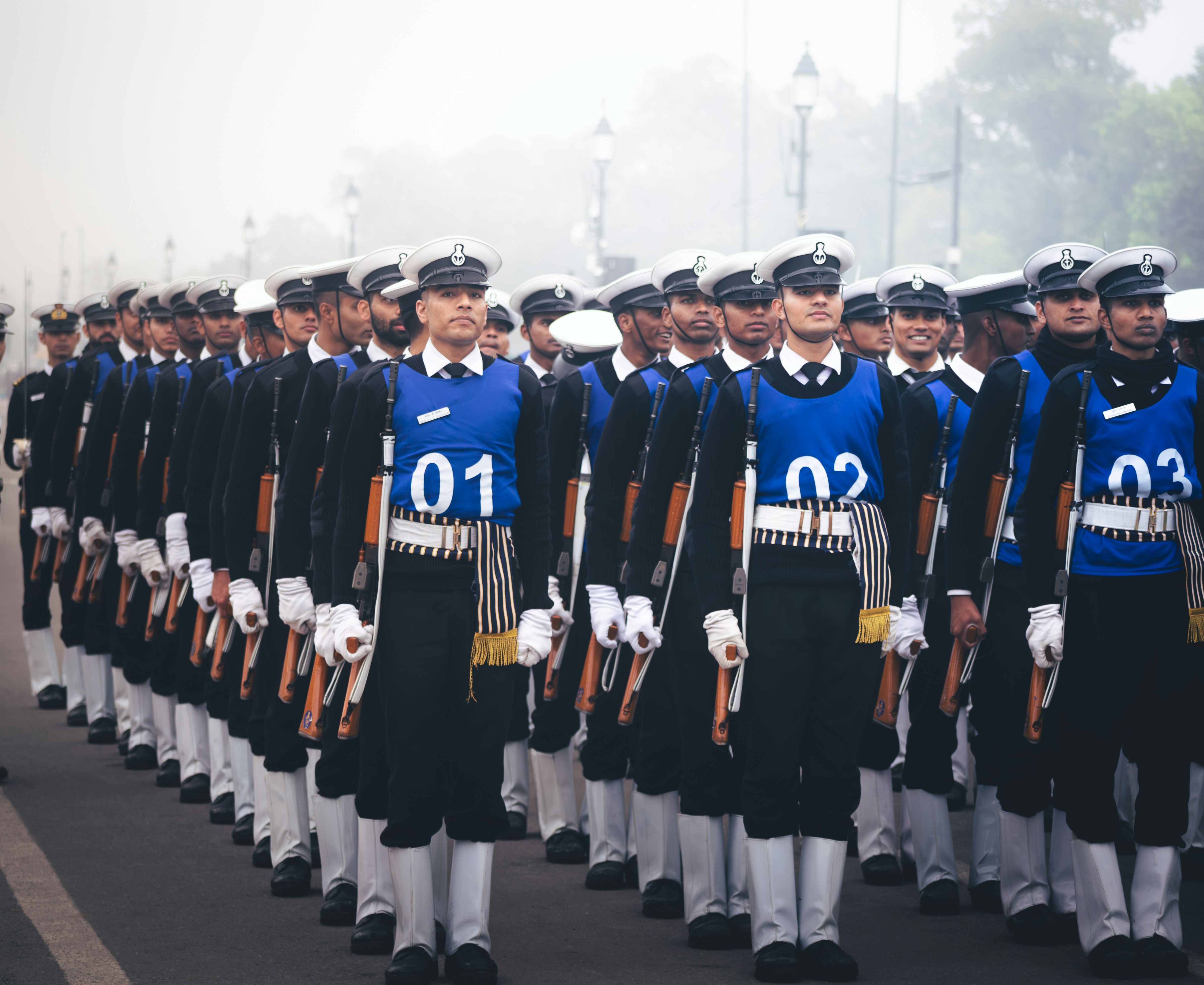 A large group of men in uniform marching down a street