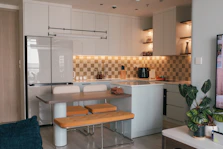 A living room and kitchen with a flat screen TV