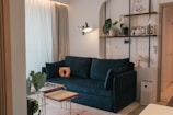 A living room with a blue couch and a coffee table