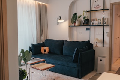 A living room with a blue couch and a coffee table