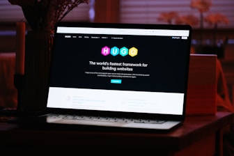 A laptop computer sitting on top of a wooden desk