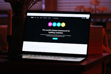 A laptop computer sitting on top of a wooden desk