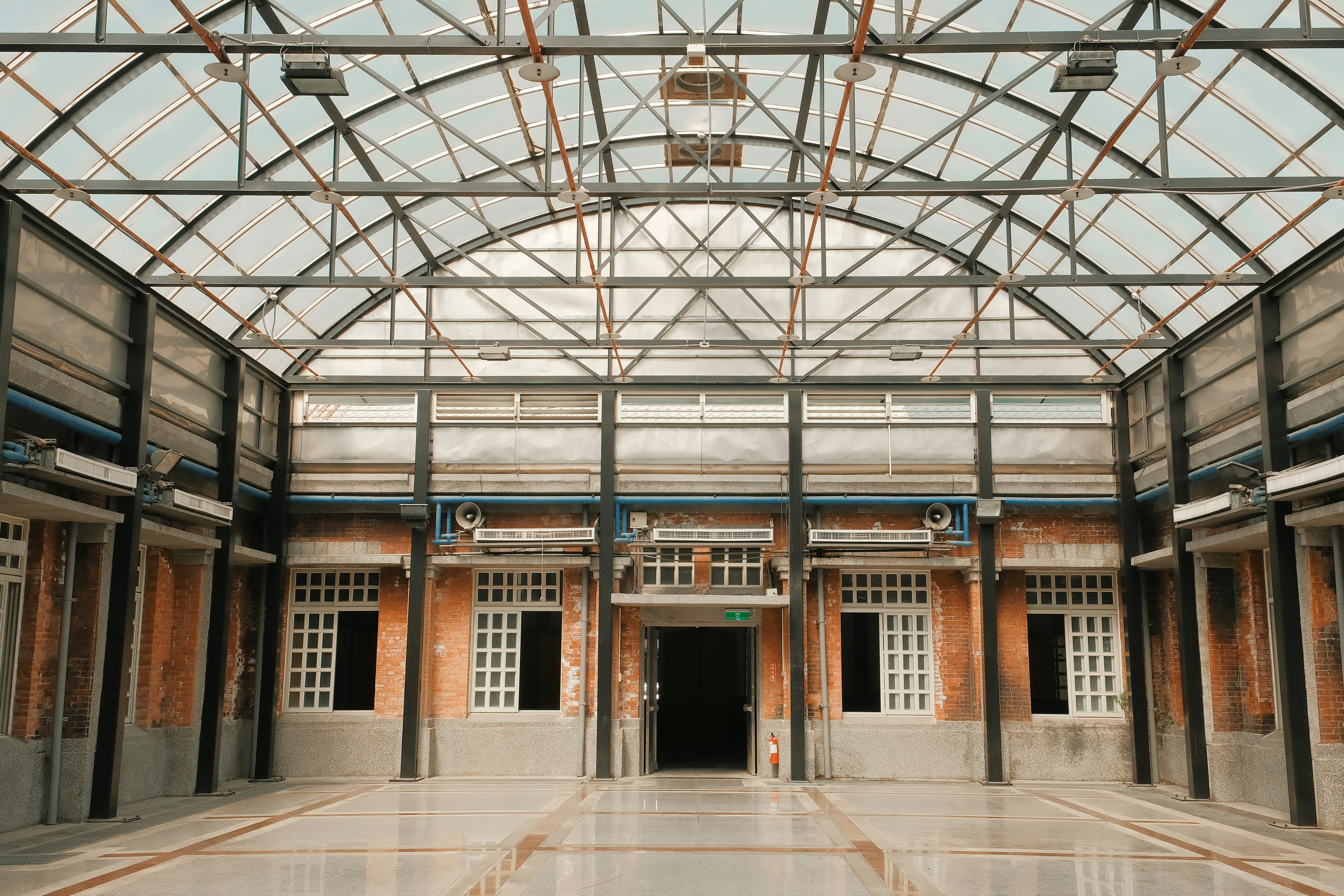 A large building with a glass ceiling and doors
