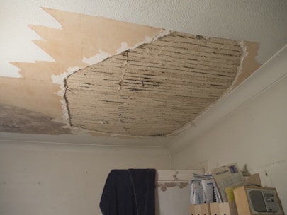 A room with a ceiling that has been torn off