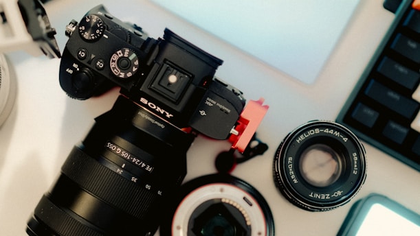 A camera sitting on top of a table next to a laptop