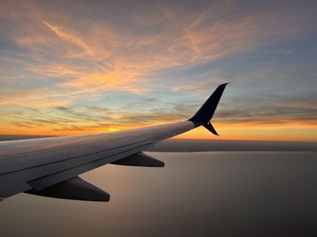 The wing of an airplane as the sun sets