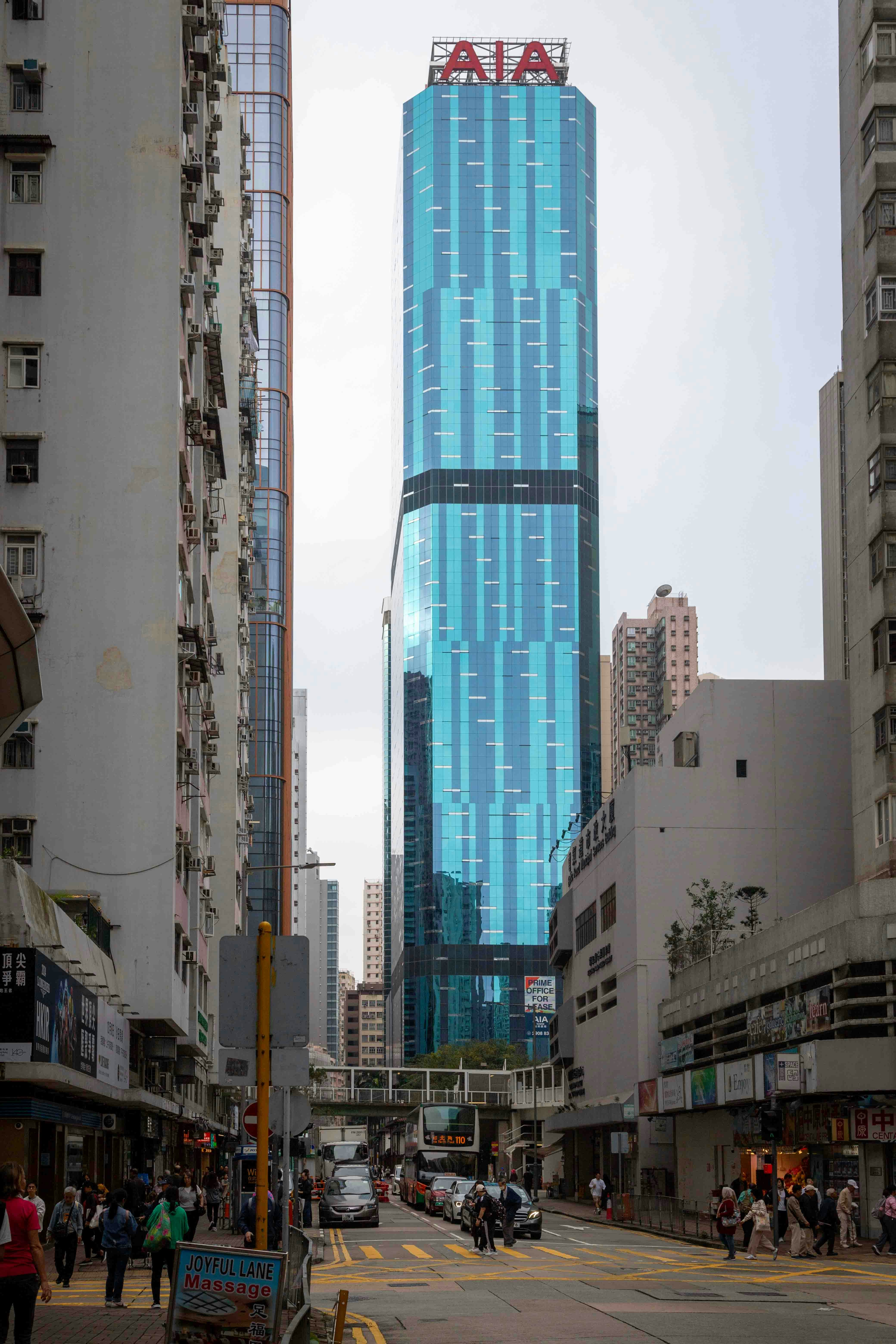 A city street with tall buildings in the background