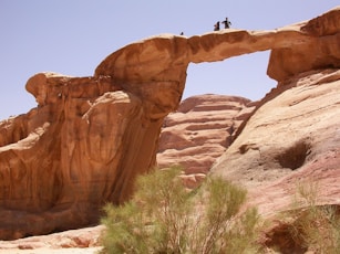 A couple of people standing on top of a rock formation