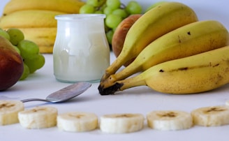 A table topped with bananas and other fruits