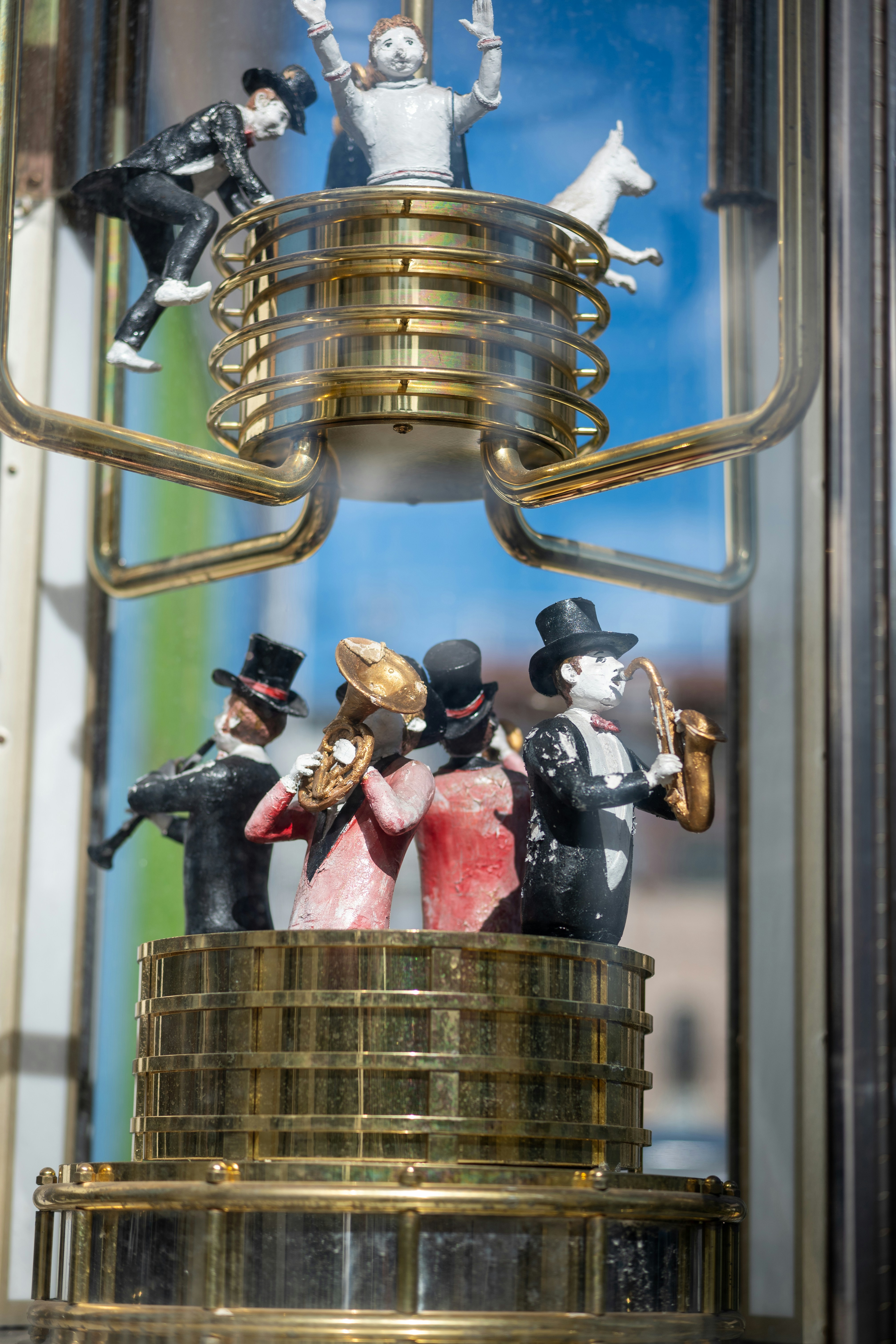 A group of figurines sitting on top of a stack of coins