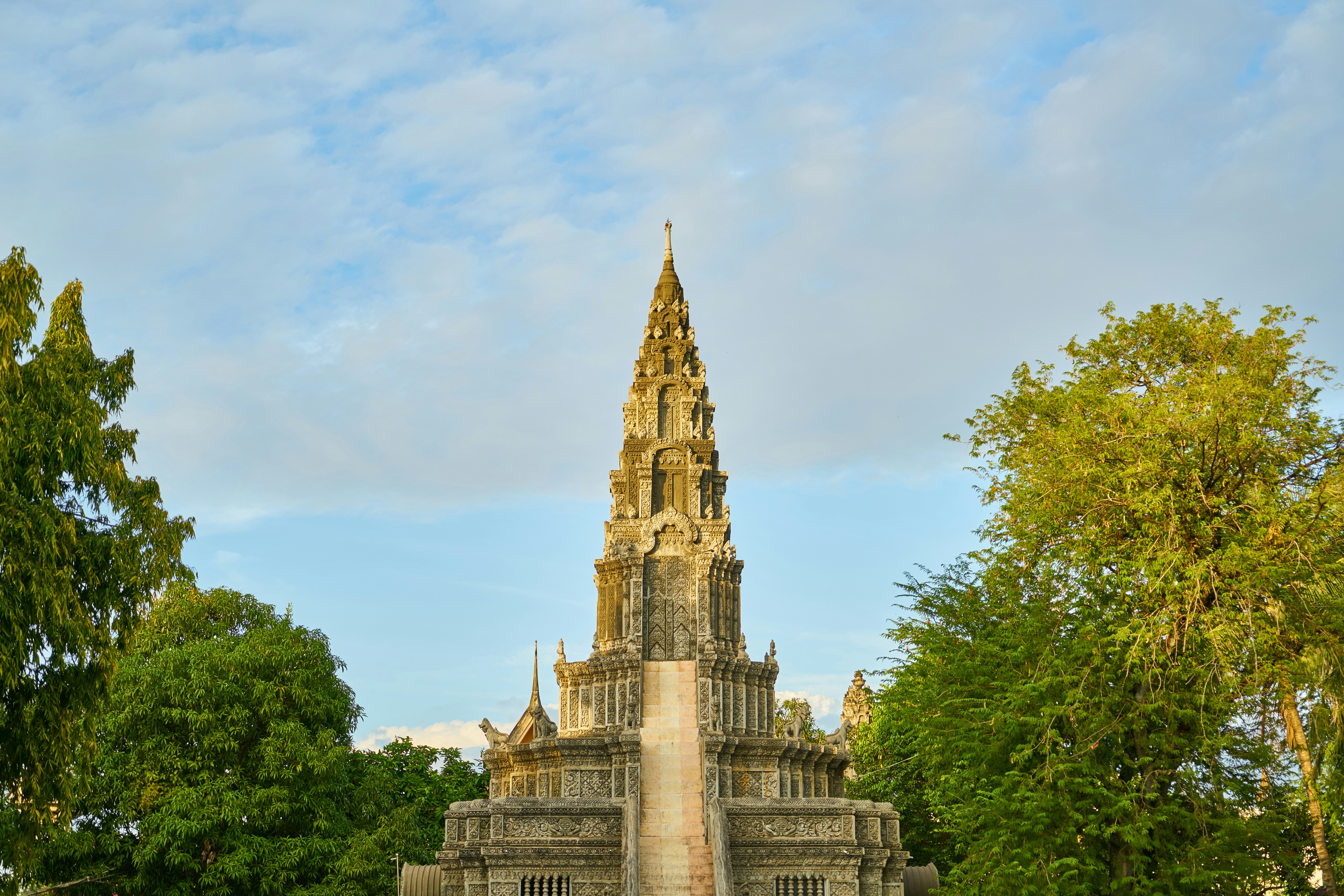 A very tall tower with a clock on it's side