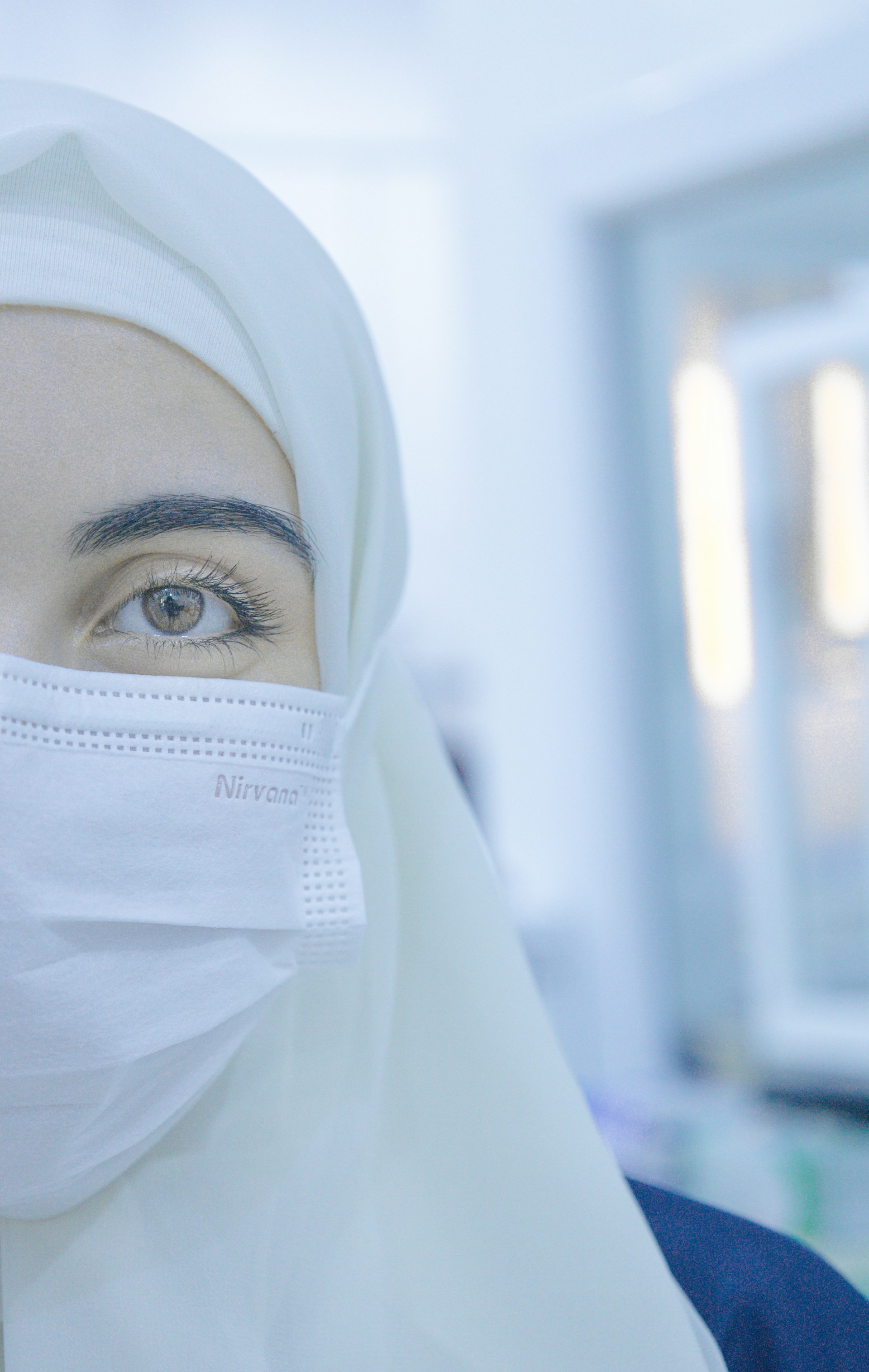 A woman in a hijab wearing a face mask