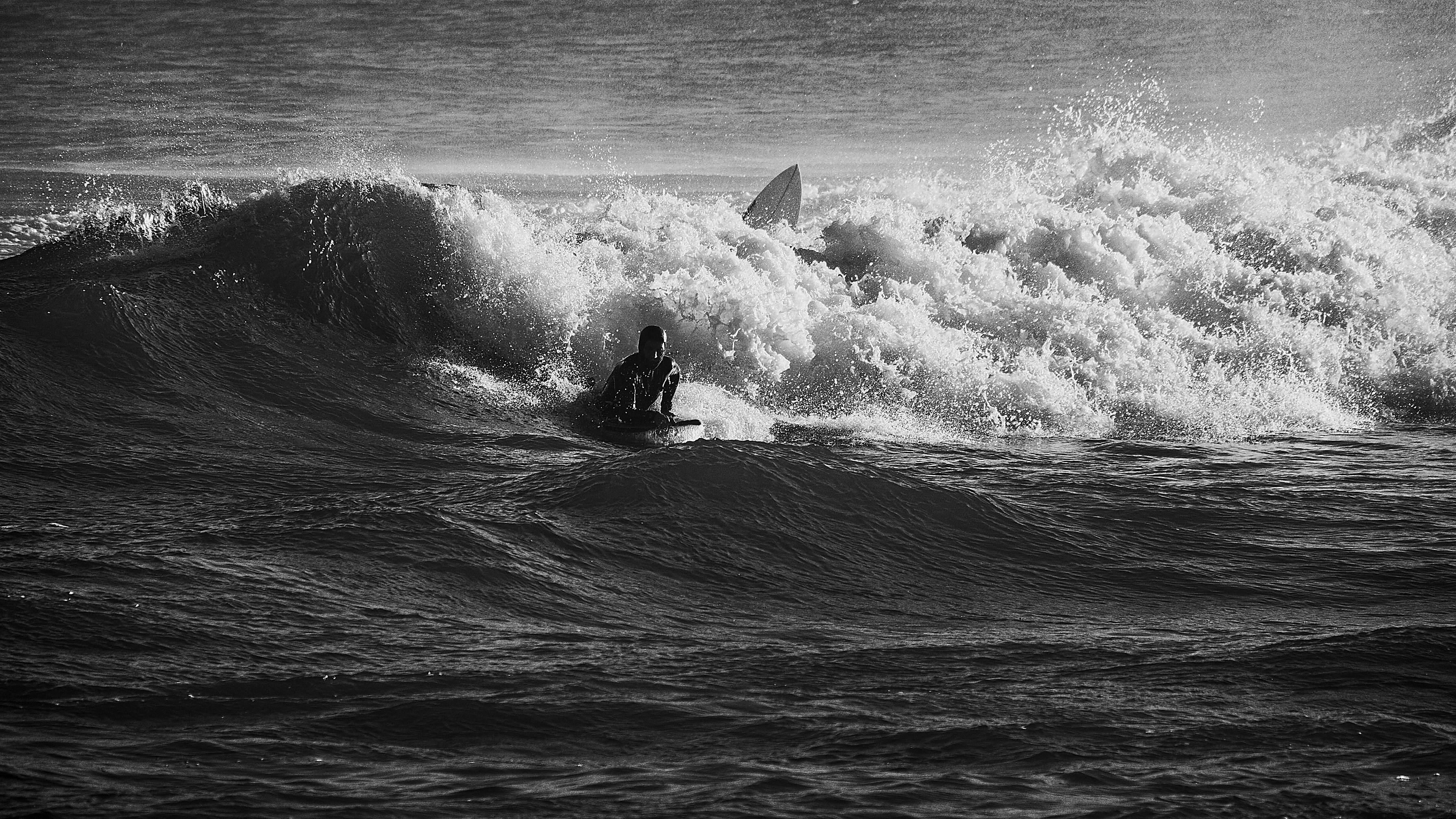 A man riding a wave on top of a surfboard
