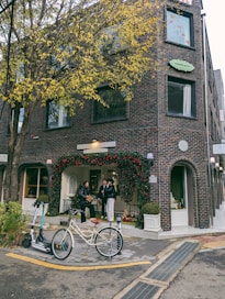 A bicycle parked in front of a tall brick building