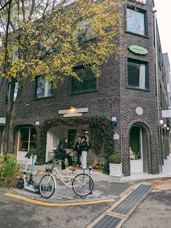A bicycle parked in front of a tall brick building