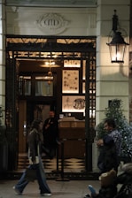 A man walking down a sidewalk next to a building