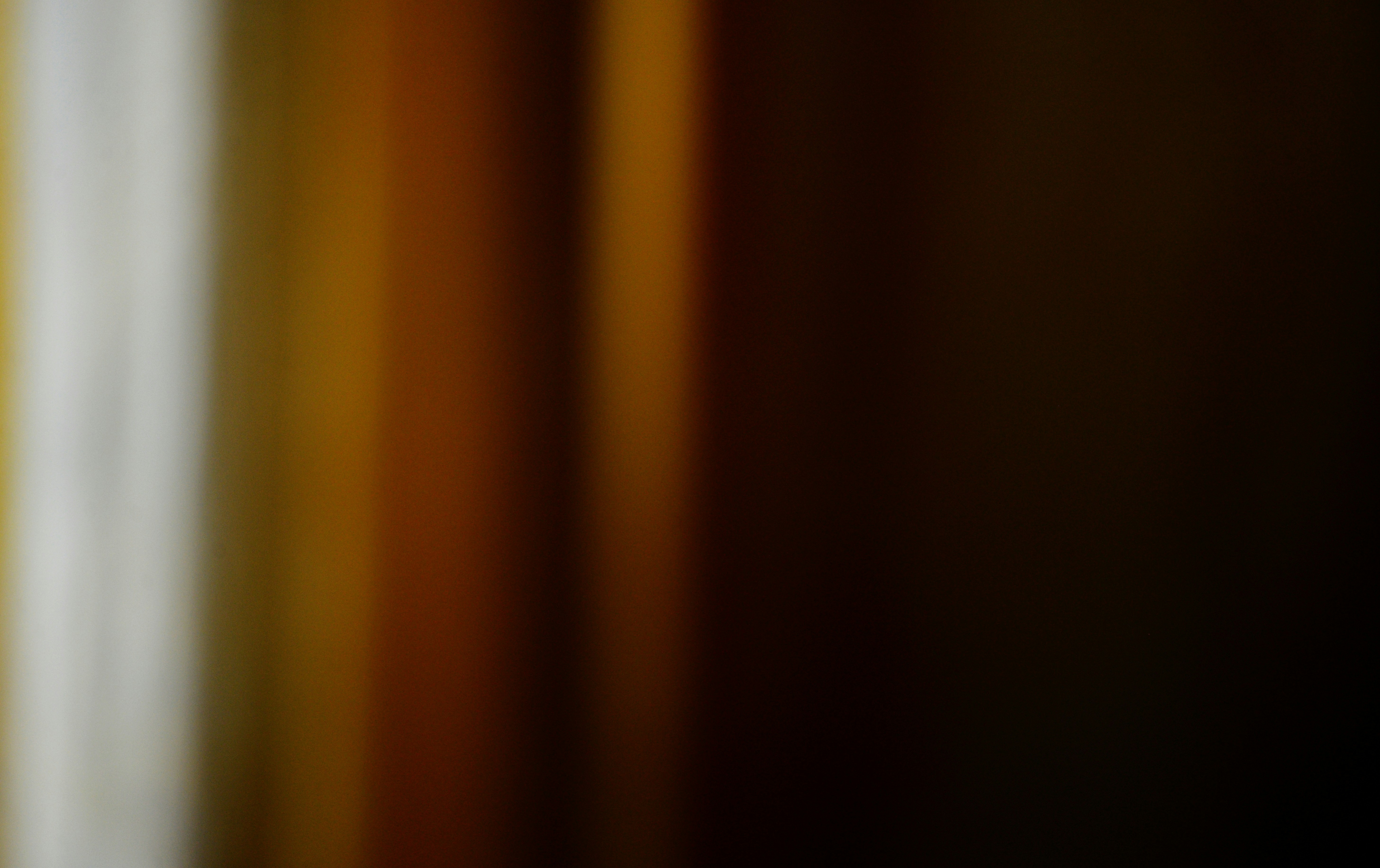 A blurry photo of a window with curtains