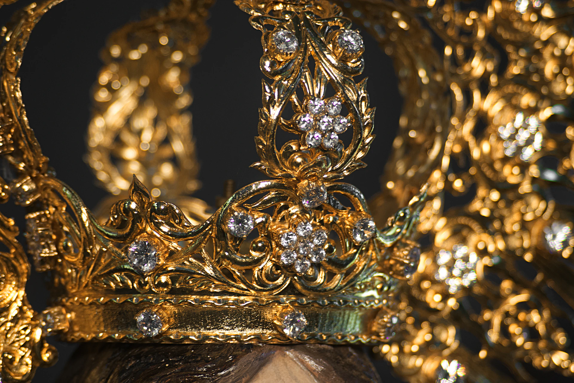 A gold crown with diamonds on top of it