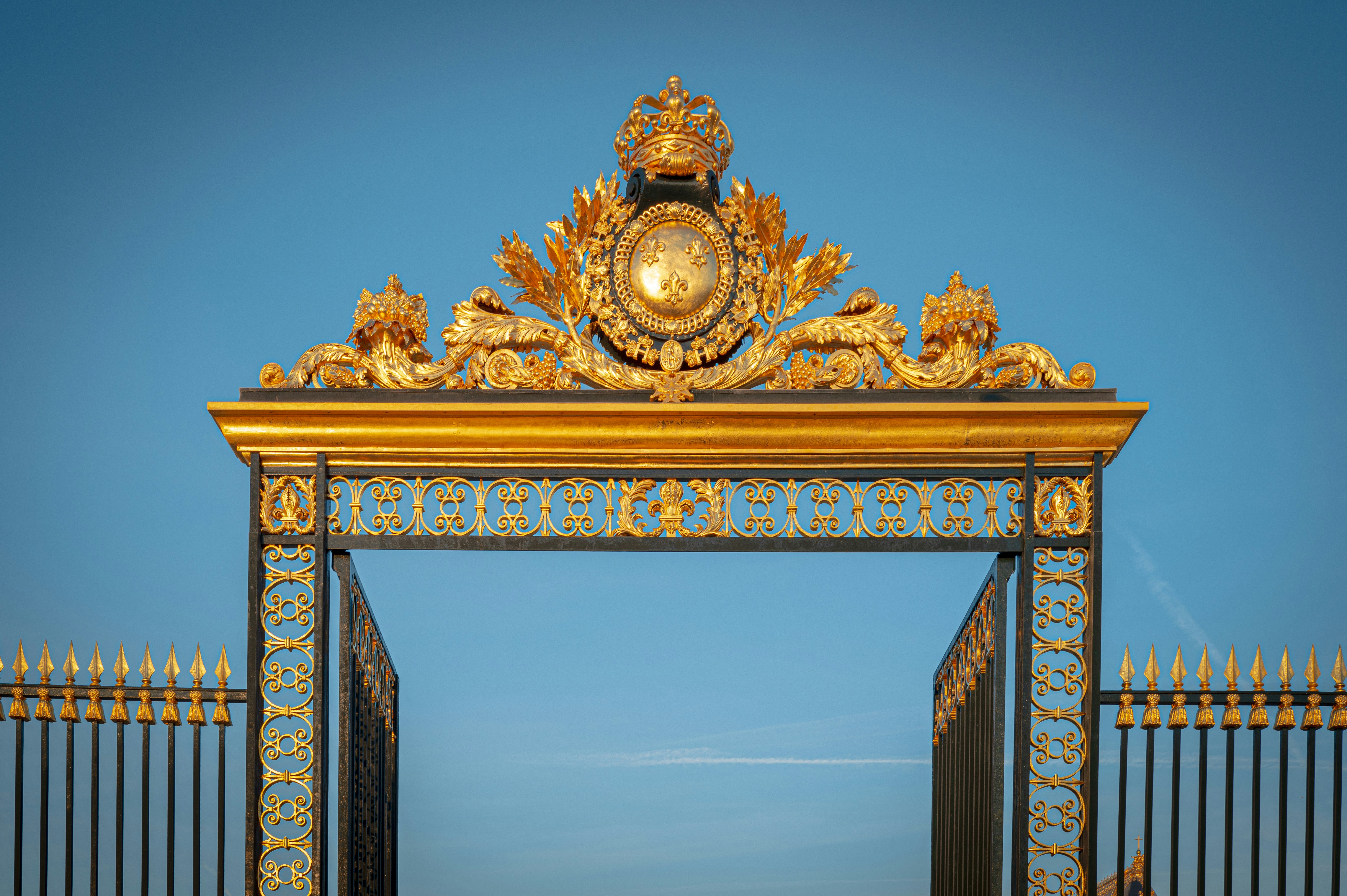 A golden gate with a clock on top of it photo Free Canton of