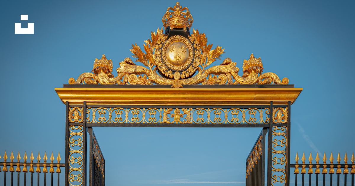A golden gate with a clock on top of it photo Free Canton of