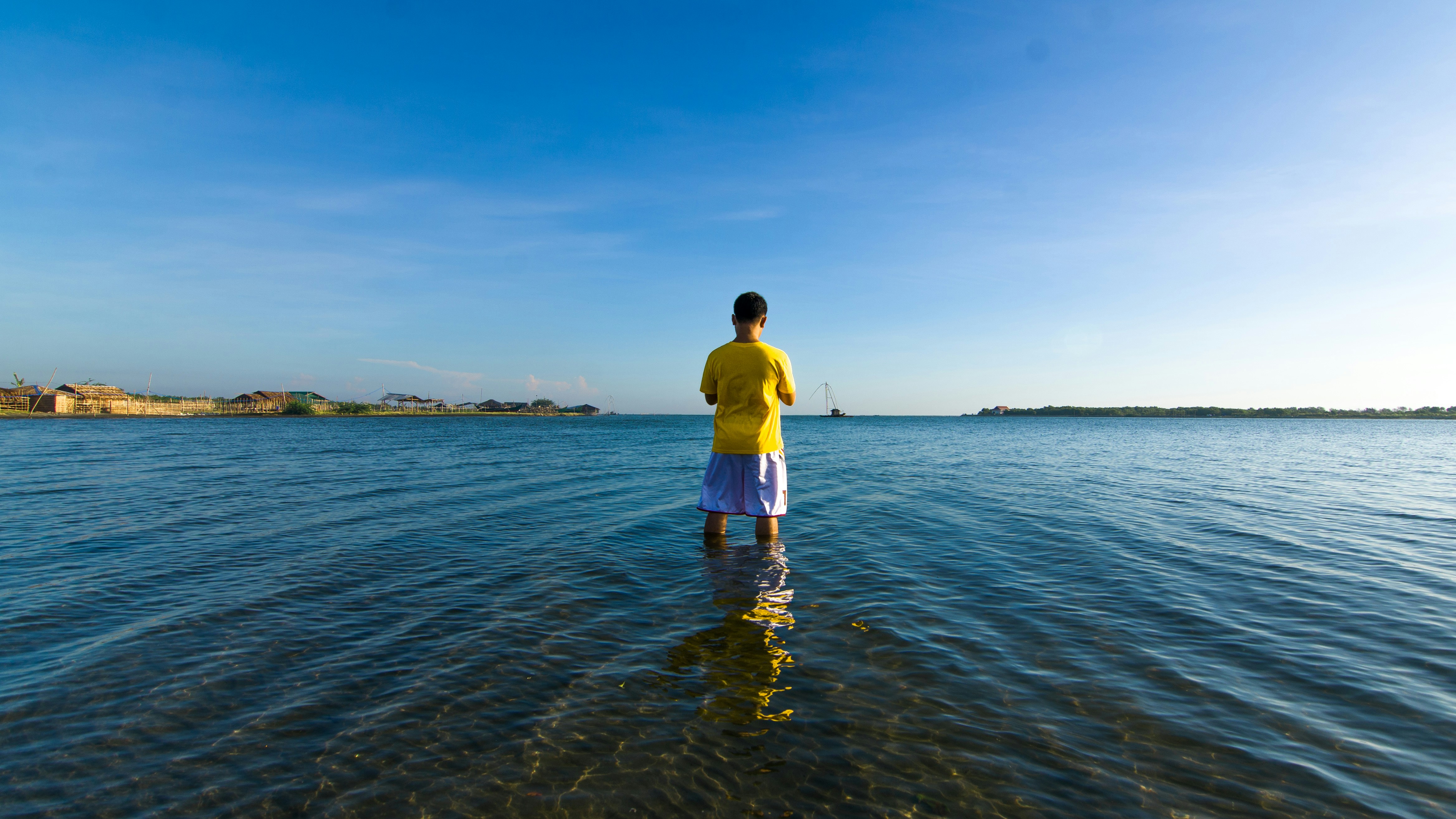 A man standing in the middle of a body of water