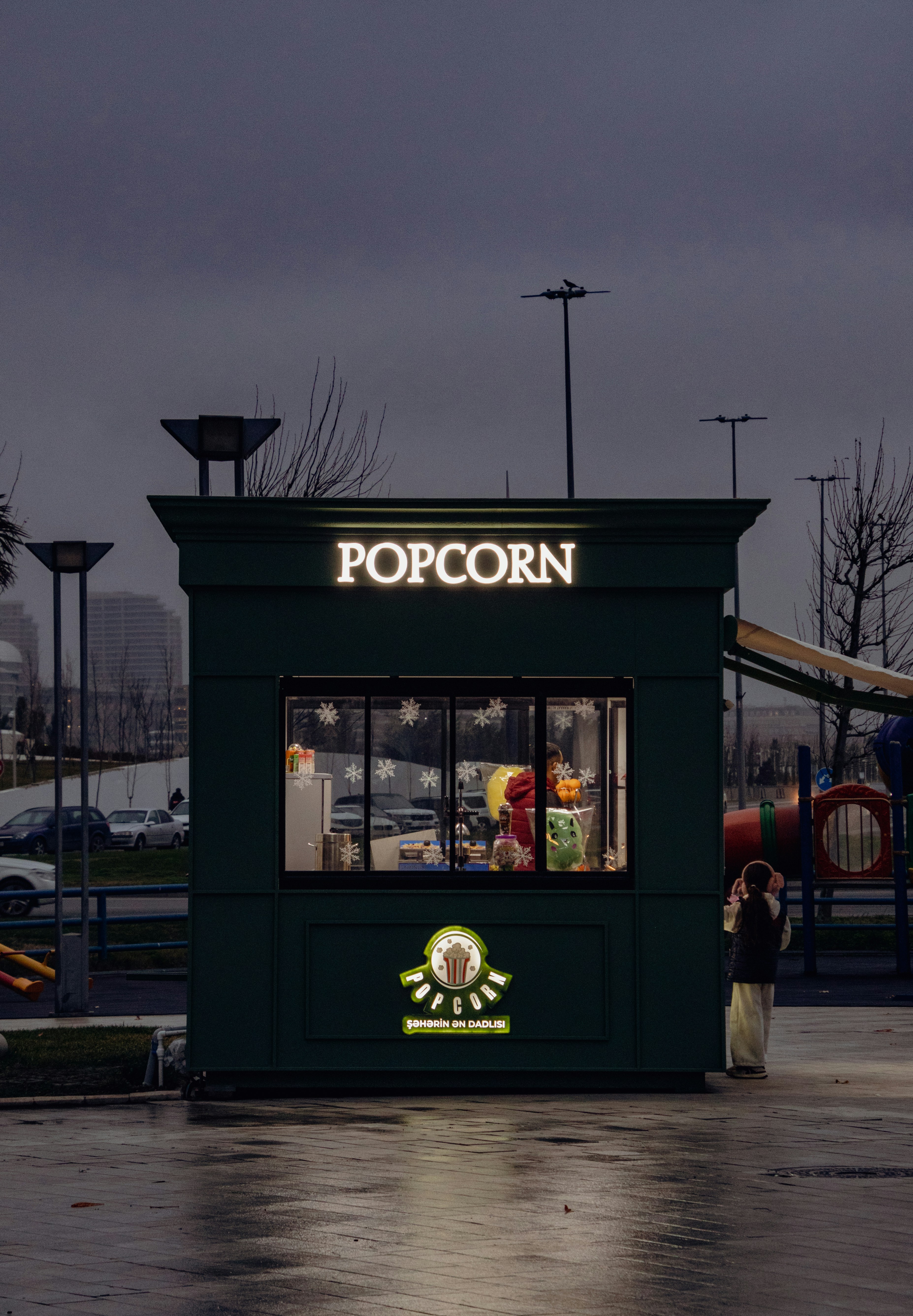 A small green building with a sign that says popcorn photo – Free City ...