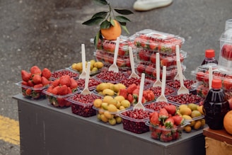 A table topped with lots of fruit and drinks