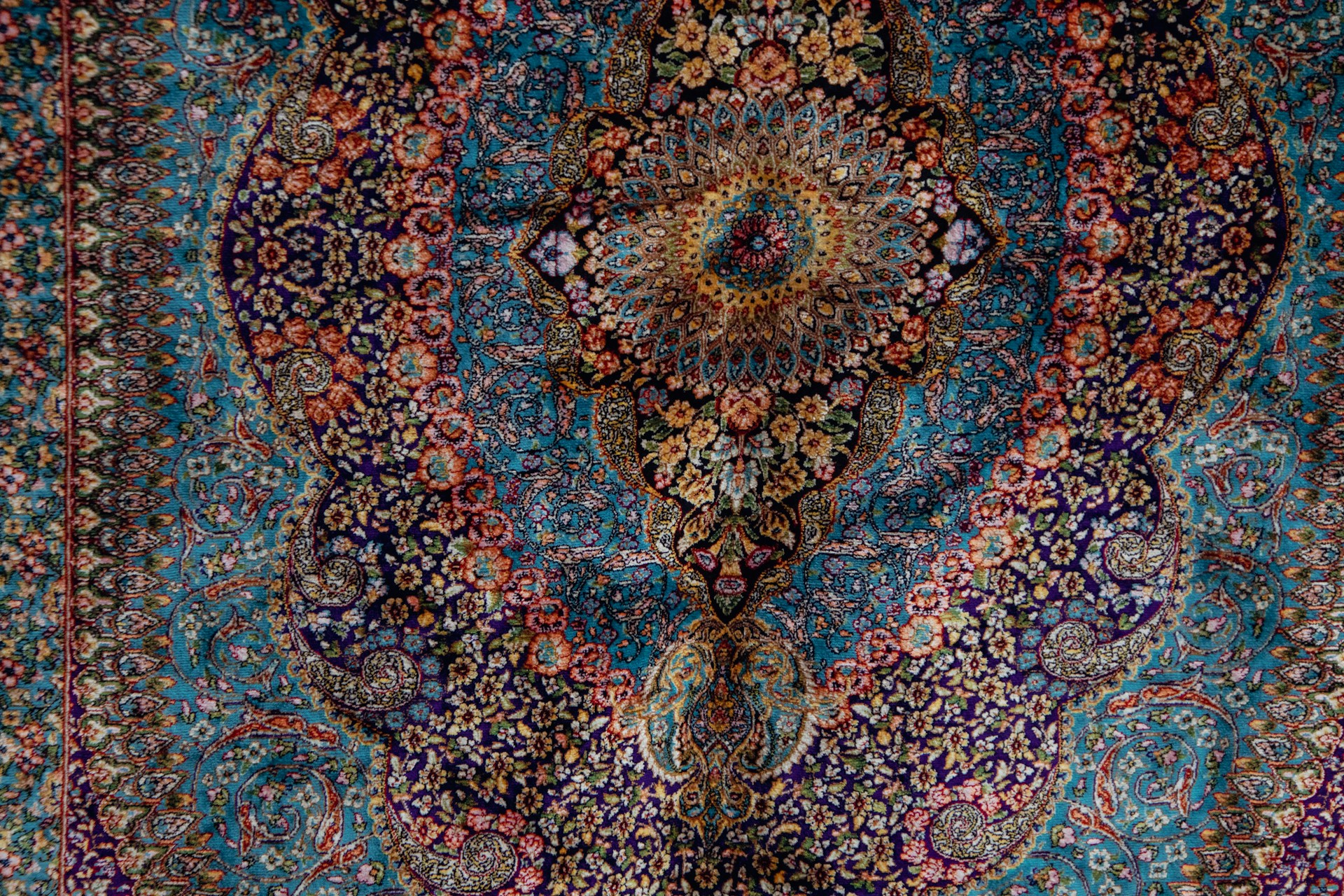 A blue and red rug with an intricate design