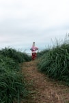A person standing in a field of tall grass