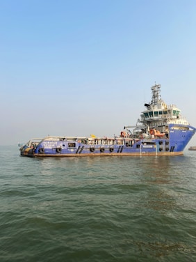 A large boat floating on top of a body of water