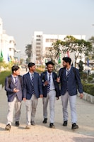 A group of young men walking down a sidewalk