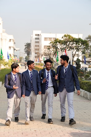 A group of young men walking down a sidewalk
