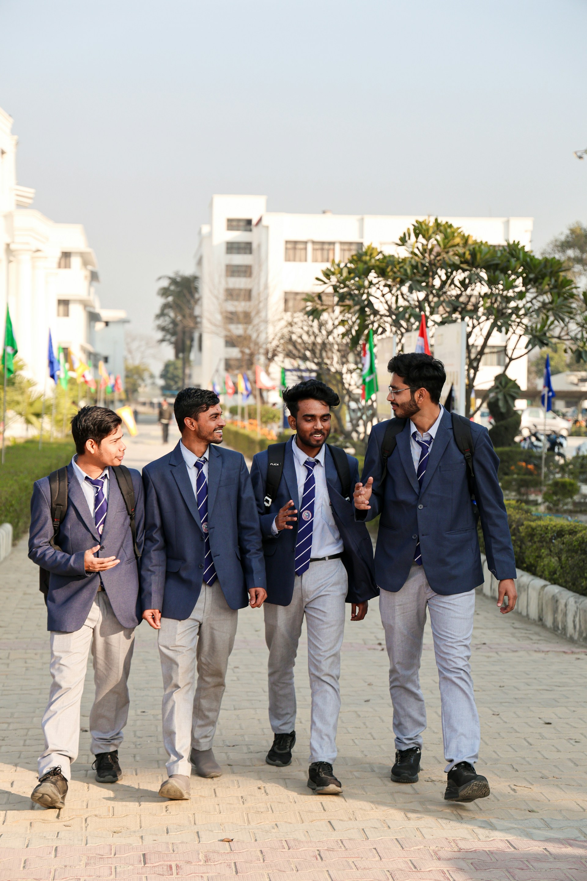 A group of young men walking down a sidewalk