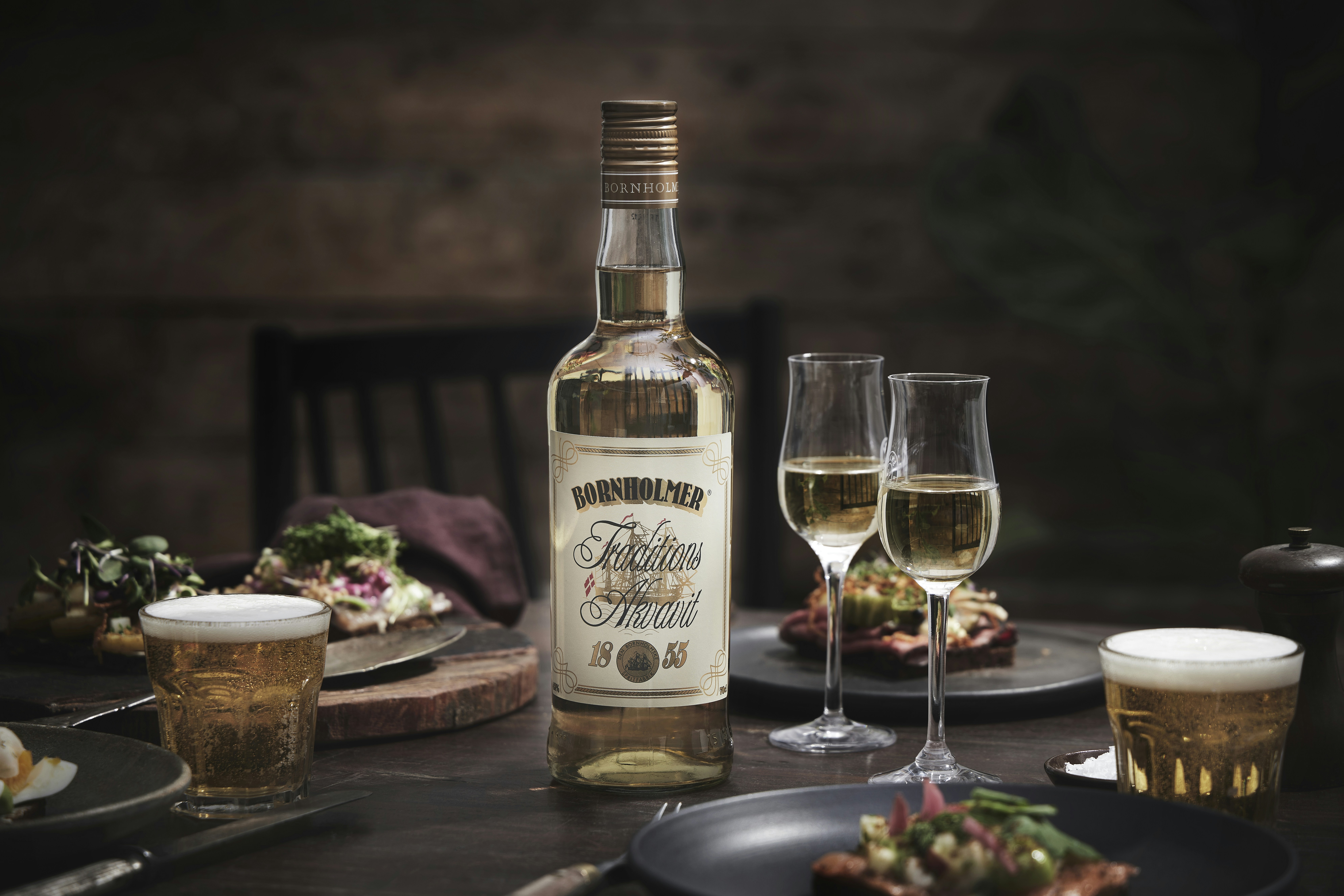 A bottle of wine and two glasses of wine on a table