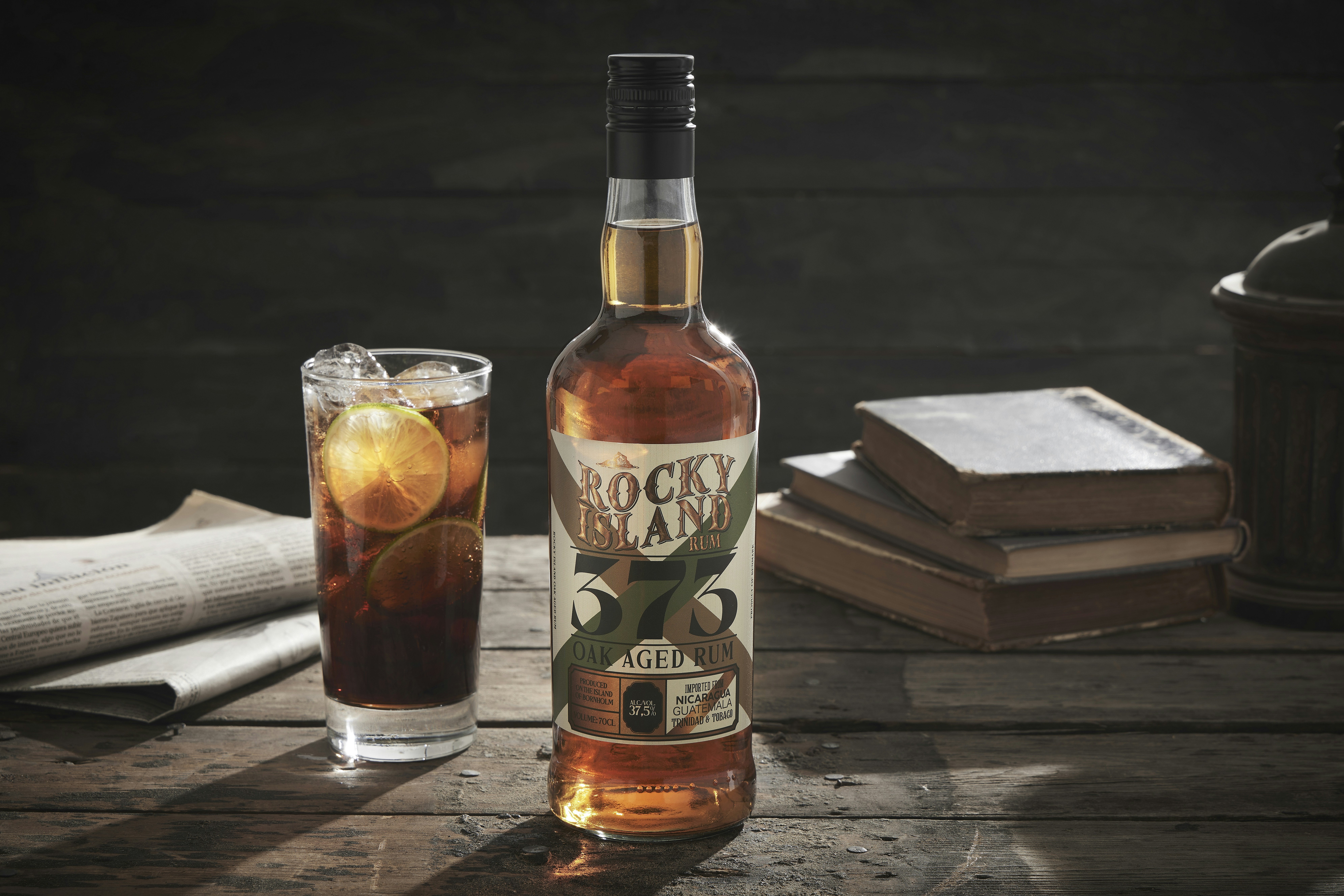 A bottle of alcohol sitting next to a glass