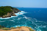 A view of the ocean from the top of a hill