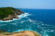 A view of the ocean from the top of a hill