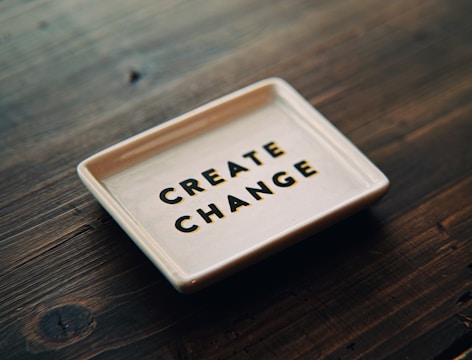 A white tray with the words create change written on it