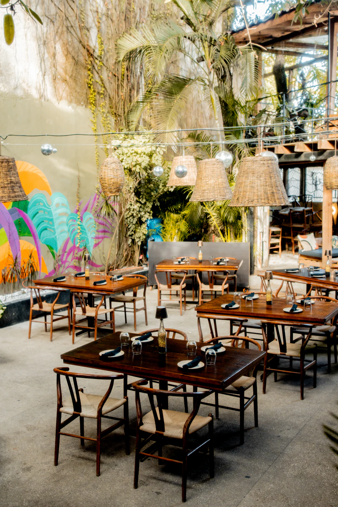 Restaurant interior showcasing expressive mural art as an architectural focal point