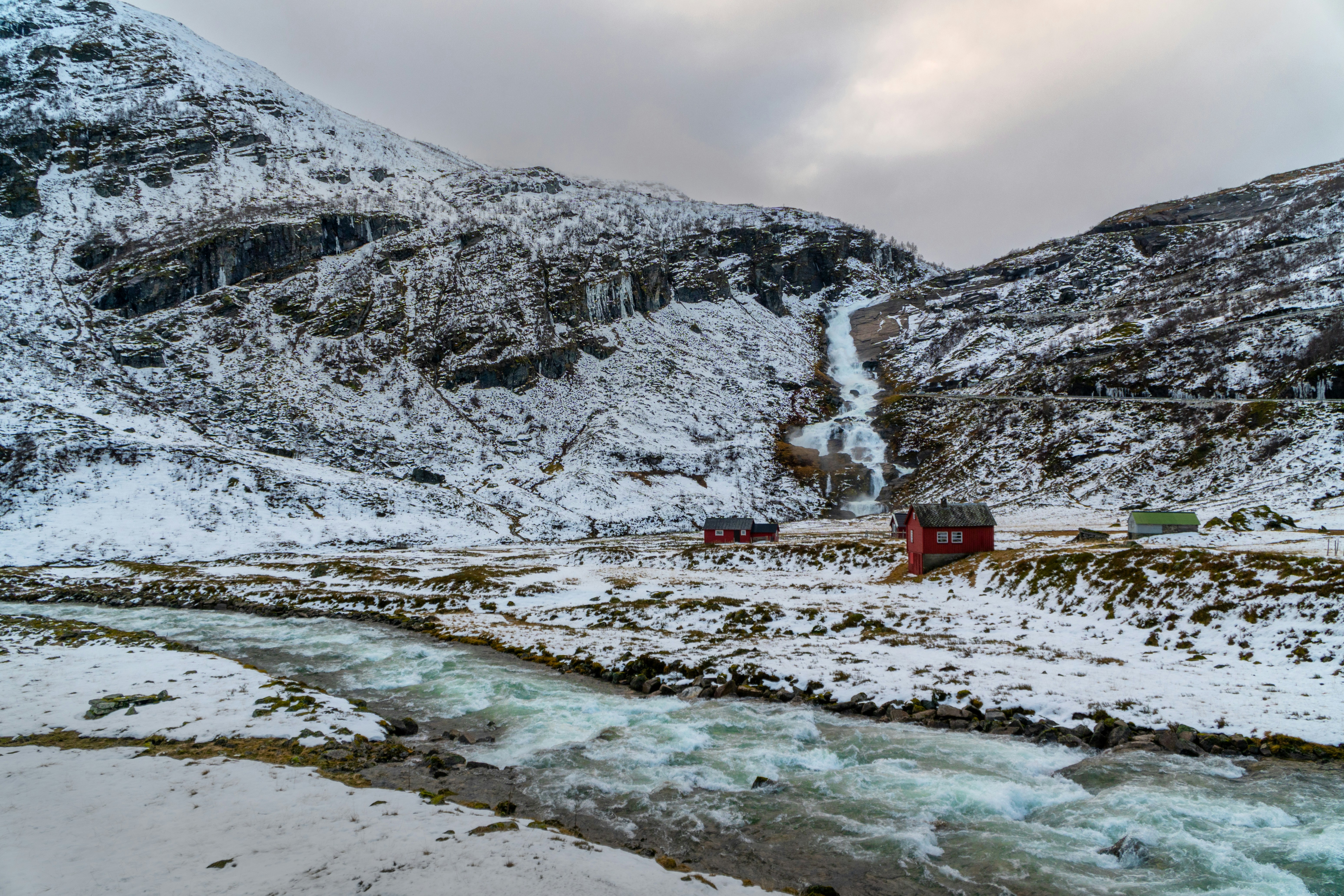 A river running through a snow covered mountain side