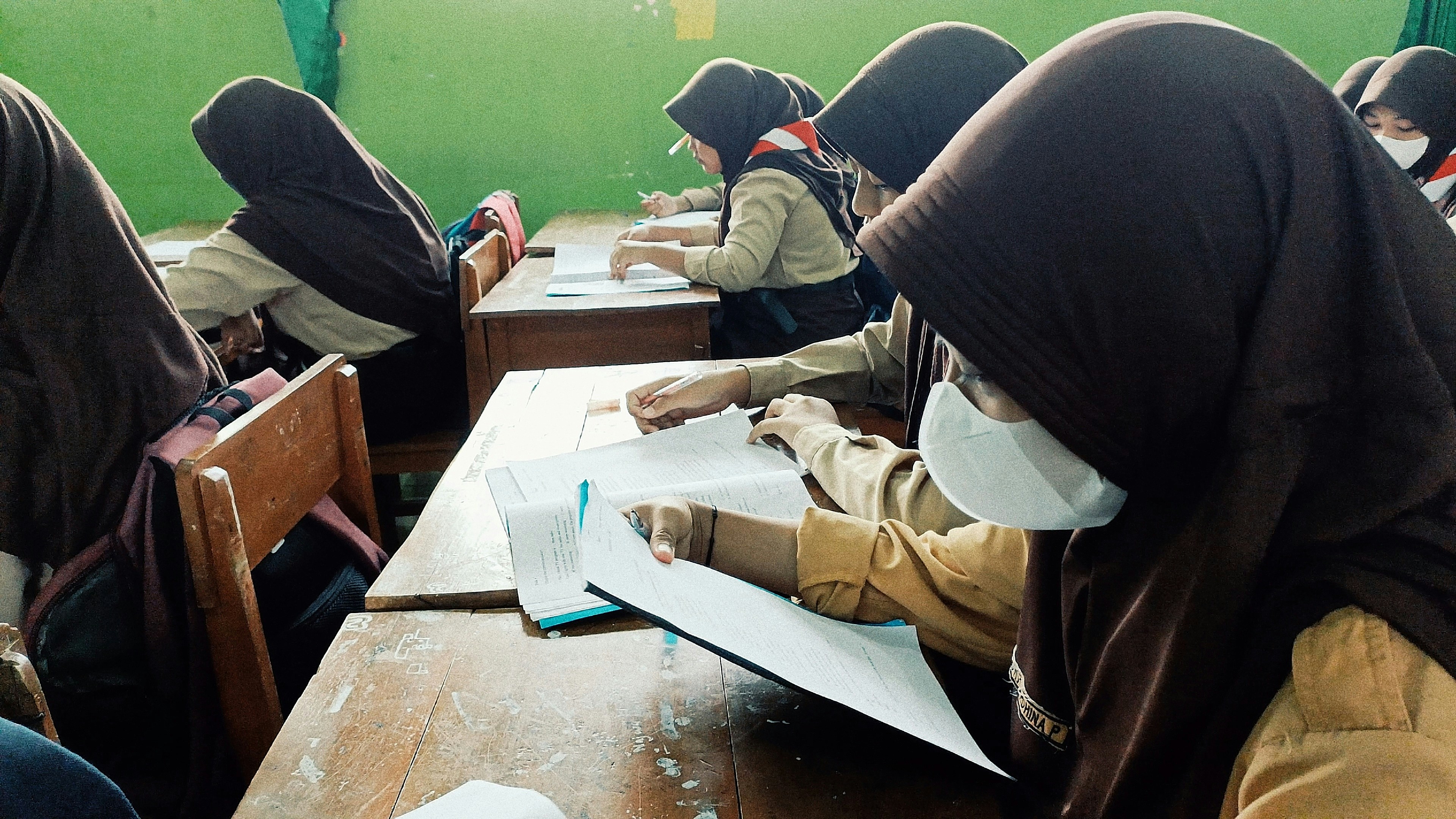 A group of people sitting at desks in a classroom