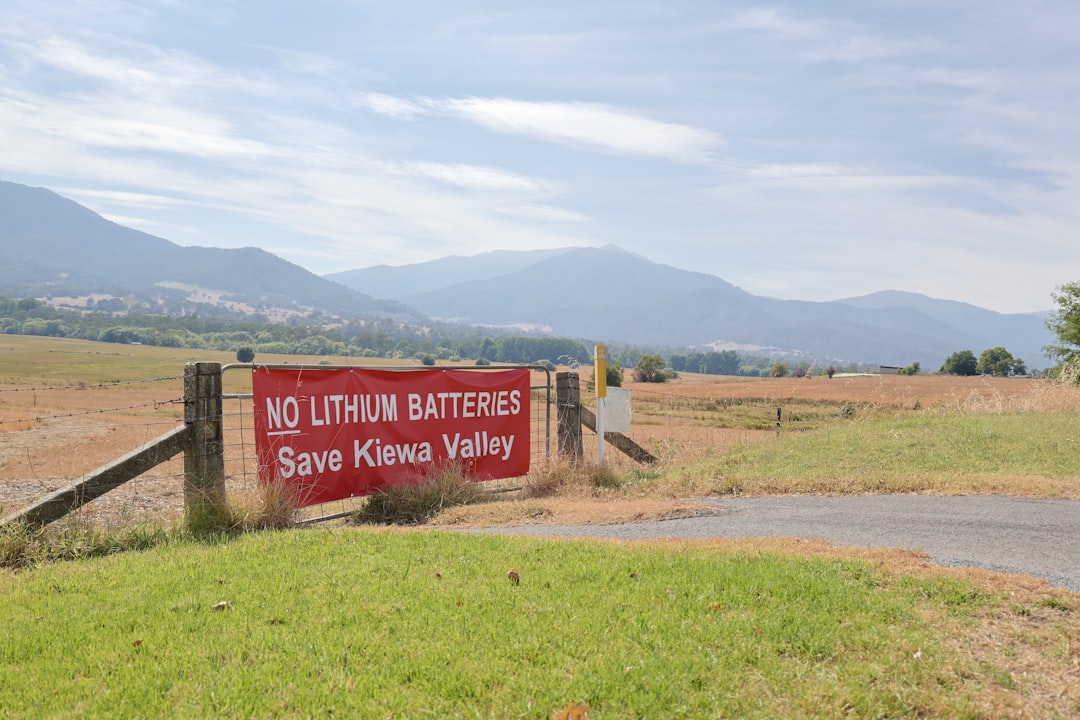 A red sign that is on the side of a road, Protest sign banner against solar farms in Australian Alpine region.