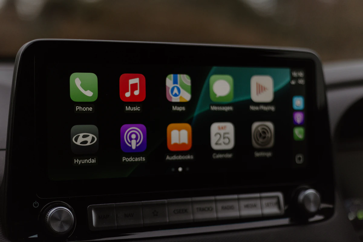 Apple CarPlay home screen with app icons displayed on a car's infotainment screen