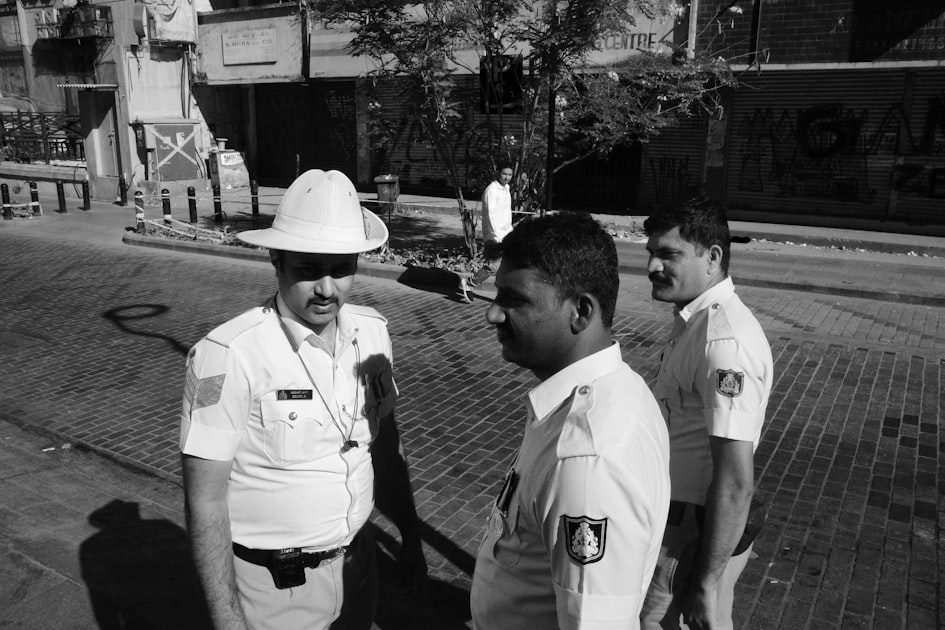 A group of men standing next to each other on a sidewalk