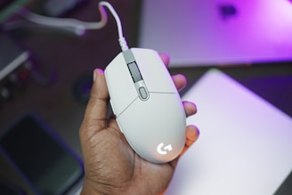 A person holding a computer mouse in their hand