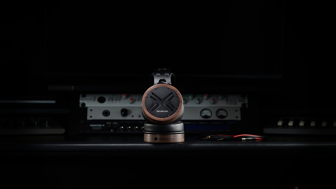 A clock sitting on top of a table in the dark, OLLO Audio X1 headphones, studio essentials for precise sound monitoring and long-lasting comfort in professional environments.