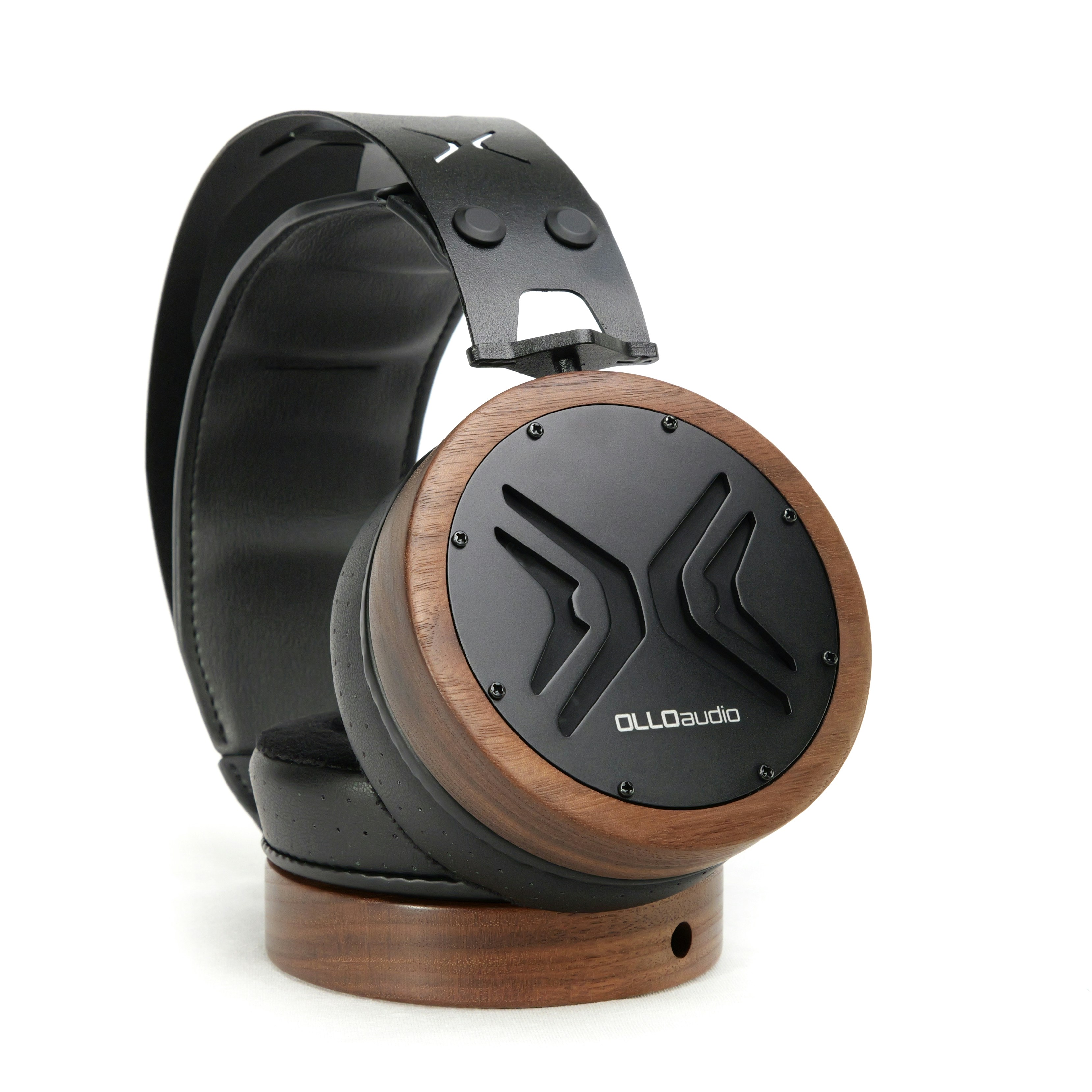 A pair of headphones sitting on top of a wooden stand