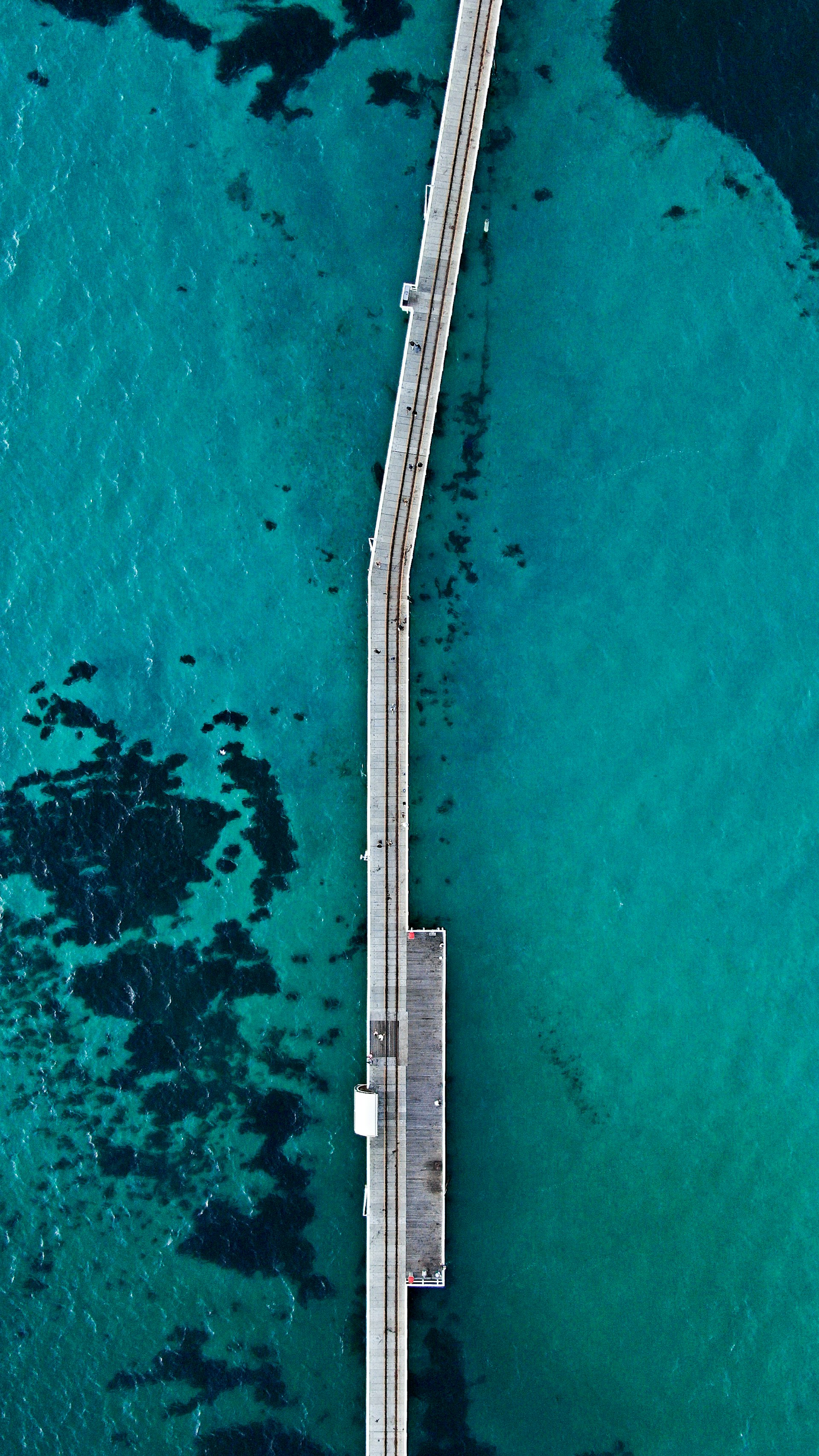 An aerial view of a bridge over a body of water