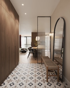 A hallway with a bench and a mirror